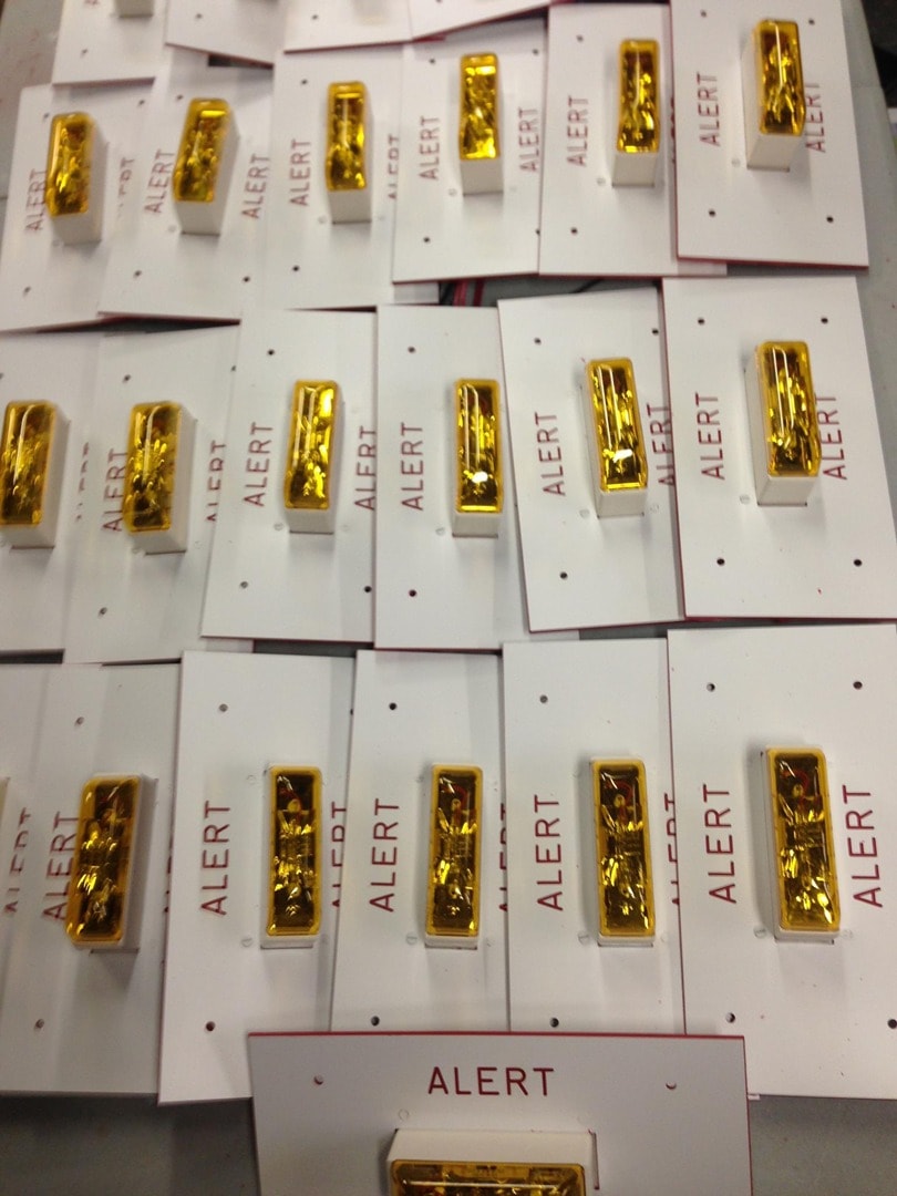 Large batch of engraved ALERT badge panels with indicator lights
