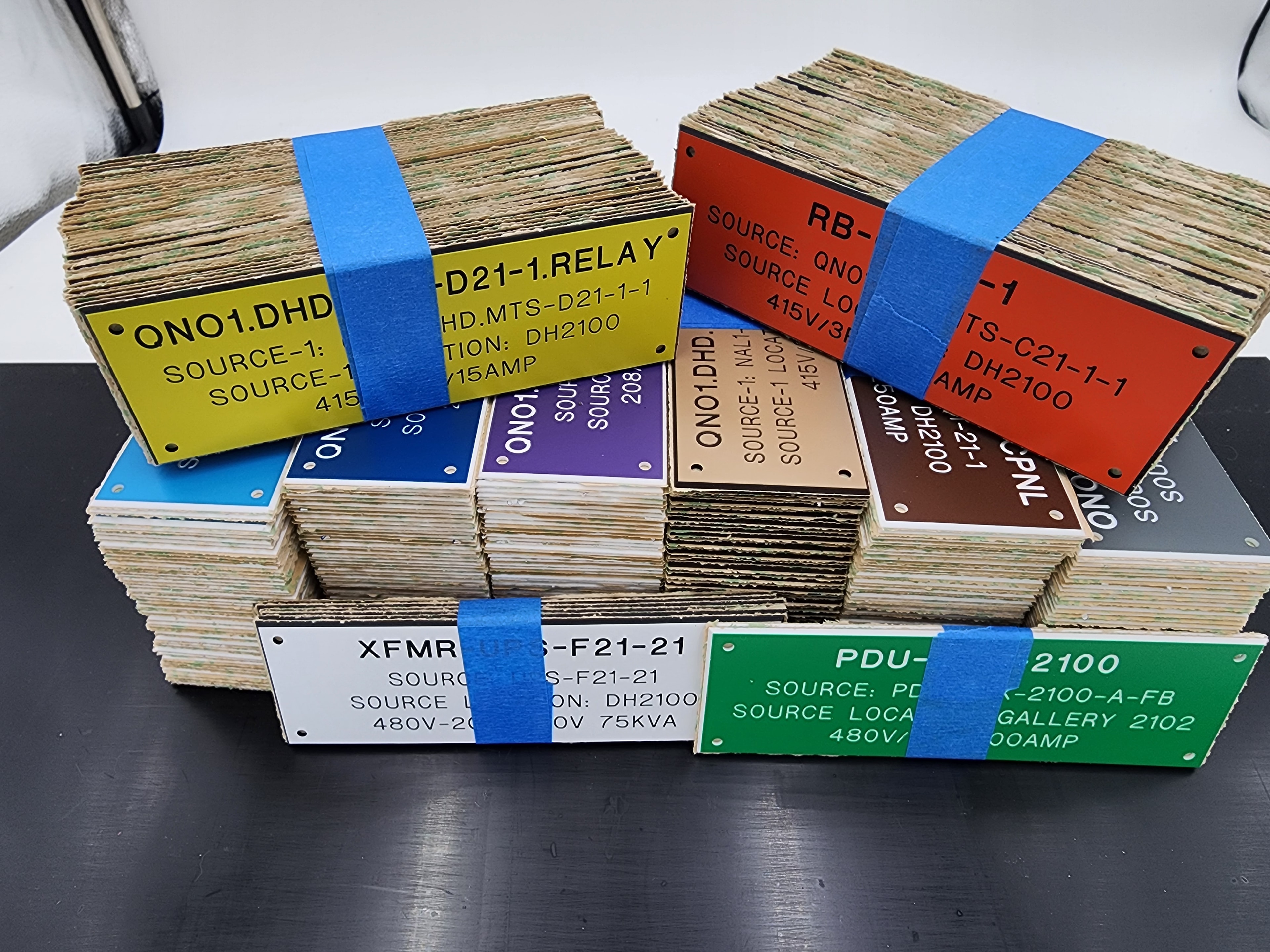 Large batch of colorful phenolic labels with engraved electrical identifiers