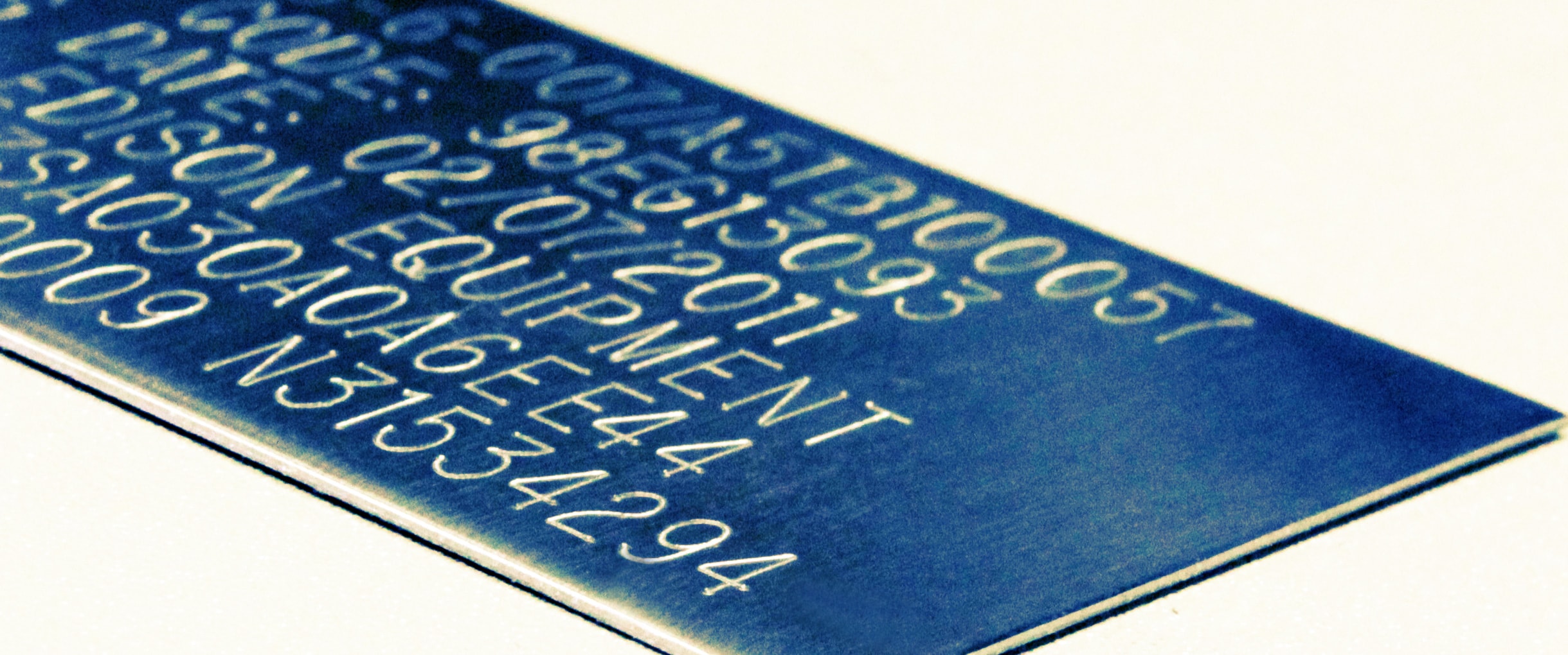 Engraved blue metal equipment tag with serial and asset numbers