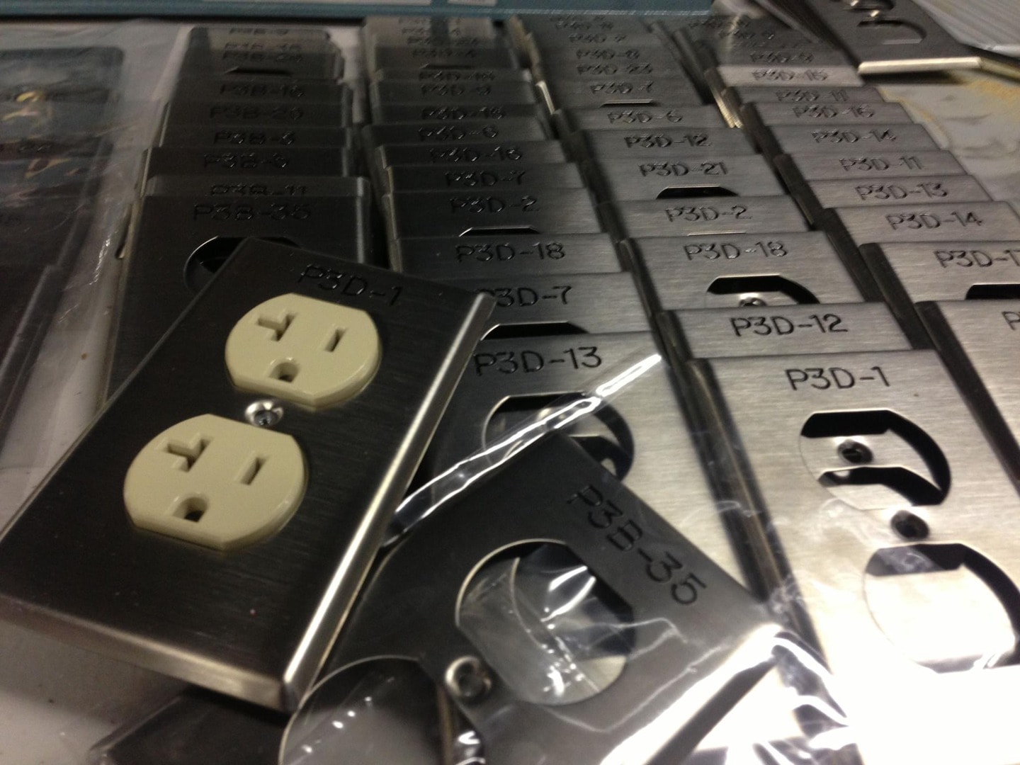 Large batch of engraved stainless P3D duplex outlet plates