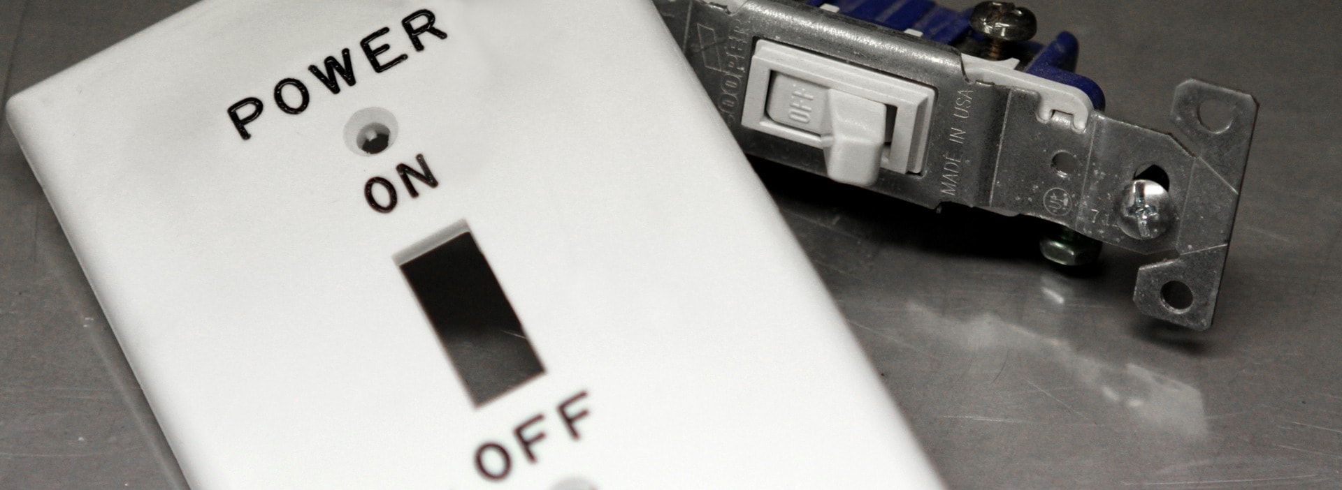 Engraved white switch plate labeled POWER ON/OFF with toggle switch