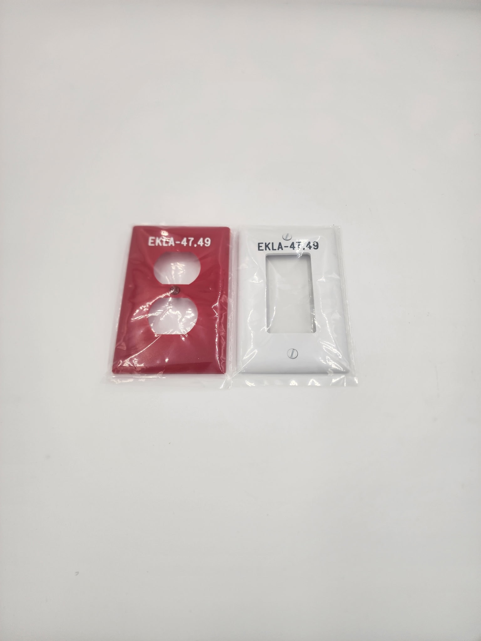 Red and white engraved outlet plates labeled EKLA-47.49