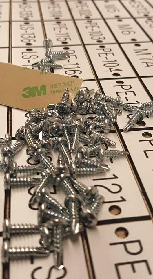 Mounting screws and 3M adhesive on an engraved label sheet with PE and LS identifiers