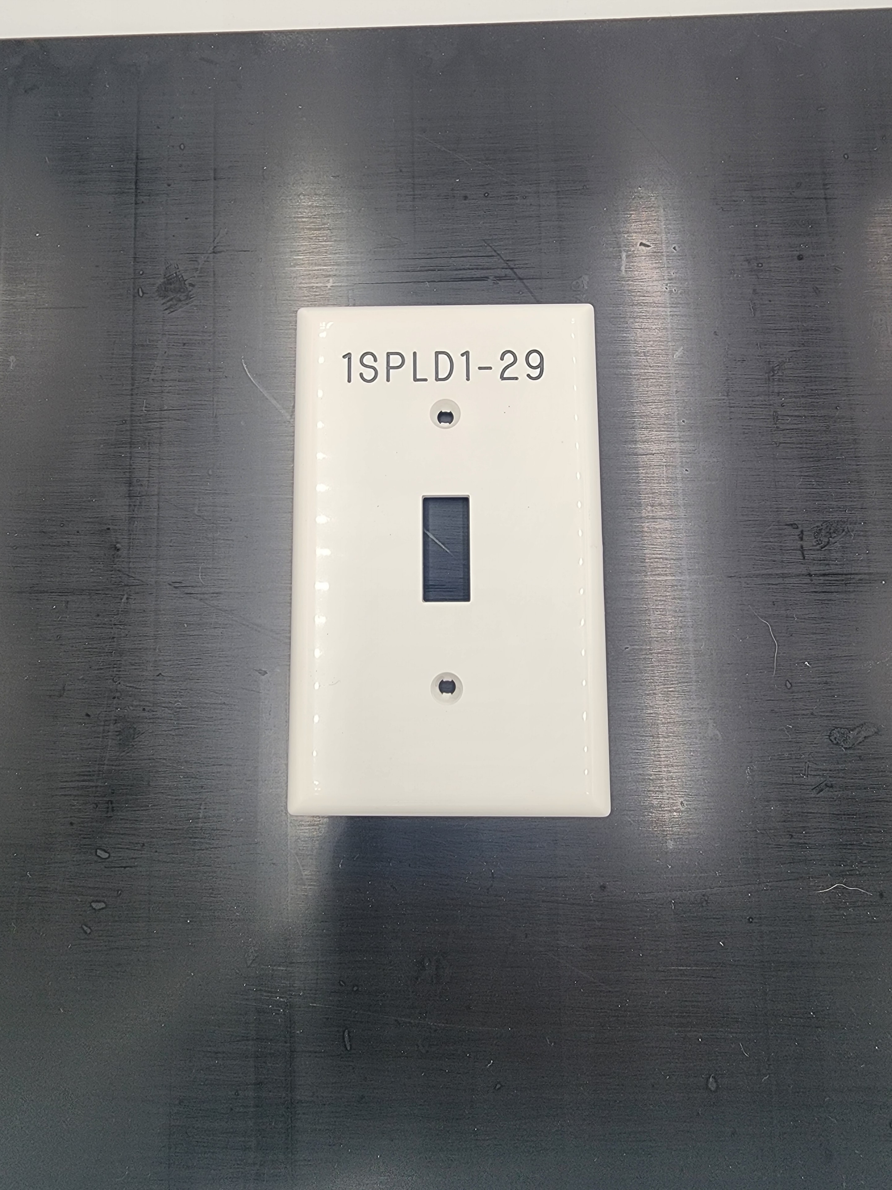 Engraved white switch plate labeled 1SPLD1-29